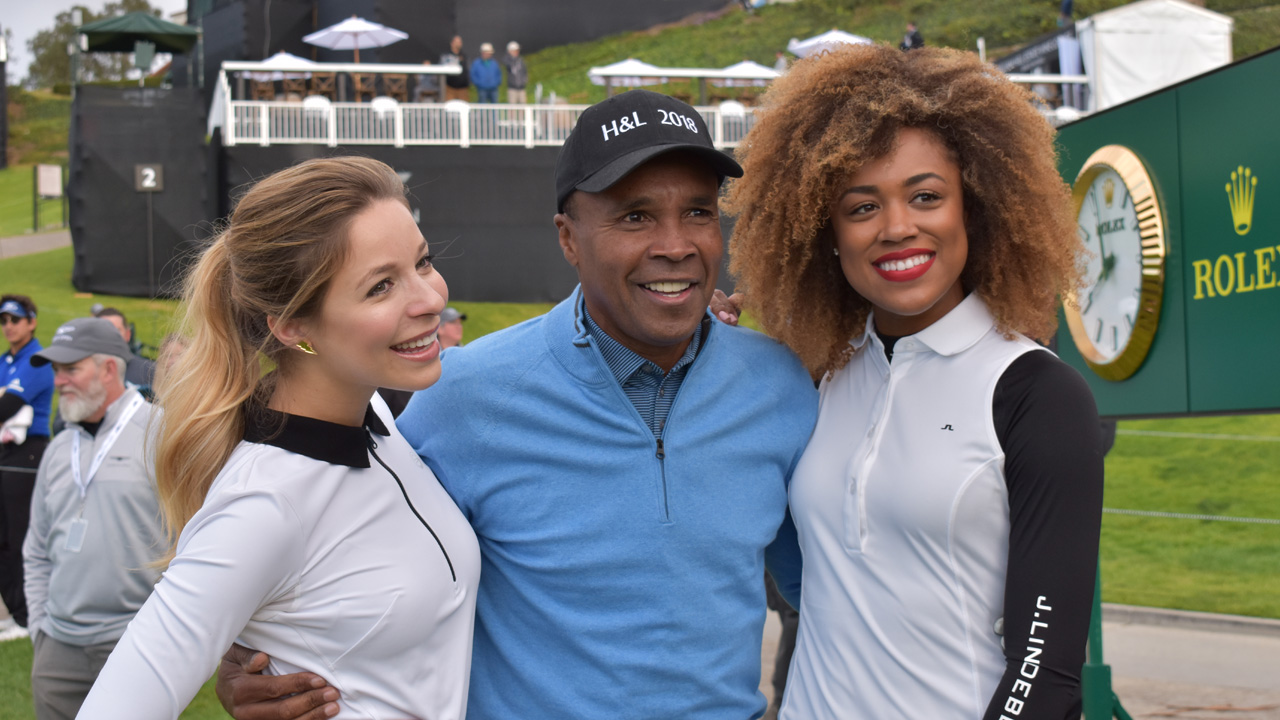 Kira Kazantsev, Sugar Ray Leonard and Troy Mullins pose for a photo before their round in the Official Genesis Open Pro-Am