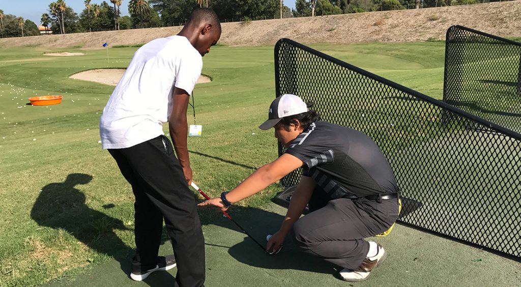 Student learns golf at TGR Learning Lab